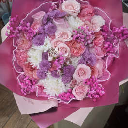 Bouquet of pink and purple flowers wrapped in magenta paper
