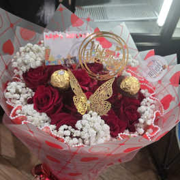 Bouquet of red roses with white baby's breath and gold decorations