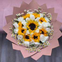 Bouquet of white roses and yellow sunflowers with small daisies