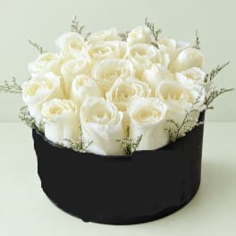 White rose bouquet in a black round box