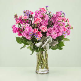 Pink and purple mixed bouquet in a clear glass vase