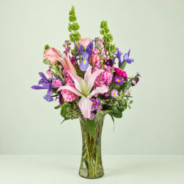 Pink and purple mixed bouquet in a clear glass vase