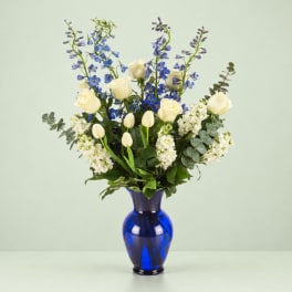 Blue and white floral arrangement in a cobalt vase