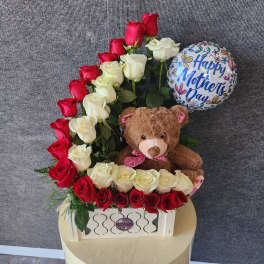 Red and white roses arranged with a teddy bear and a Mother's Day balloon