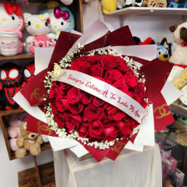 Bouquet of red roses with a ribbon and white baby's breath
