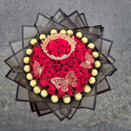 Bouquet of red roses with gold chocolates and butterfly decorations