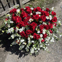 Large bouquet of red roses and white flowers on the ground