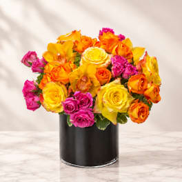 Bouquet of yellow, orange, and pink roses in a black vase