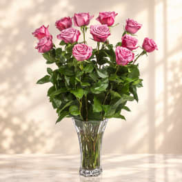 Pink roses arranged in a clear glass vase
