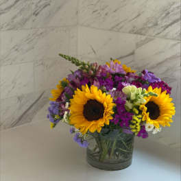 Mixed bouquet with sunflowers in a glass vase