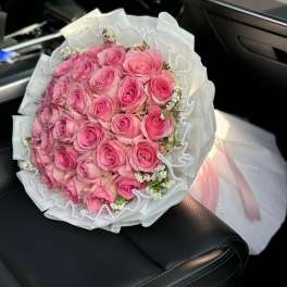 Pink rose bouquet with white wrapping