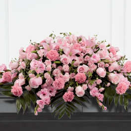 Large pink floral casket spray with roses and lilies