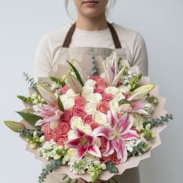 Large bouquet of pink and white roses with pink lilies