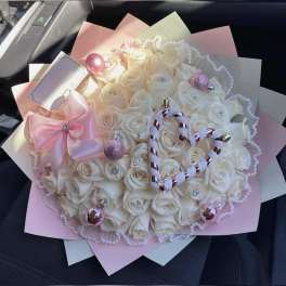 Bouquet of white roses with pink ribbon and pearl accents