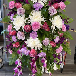 Tall floral spray with white chrysanthemums, pink roses, and purple blooms