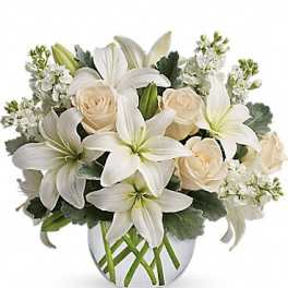 White lilies and cream roses in a glass vase