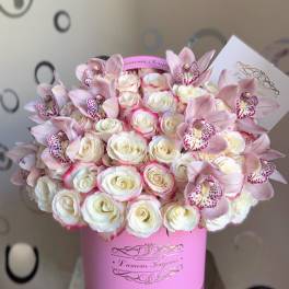 Pink and white roses with pale pink orchids in a pink box