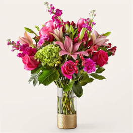 Pink and magenta flower arrangement in a clear glass vase