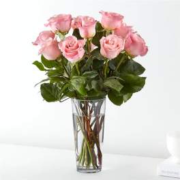 Pink roses arranged in a clear glass vase