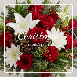 Christmas bouquet with red roses, white lilies, and pinecones