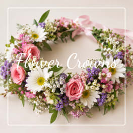 Floral crown with pink roses, white daisies, and purple filler flowers