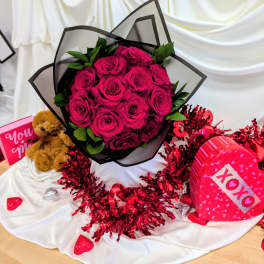 Bouquet of hot pink roses with a teddy bear and heart-shaped gift boxes