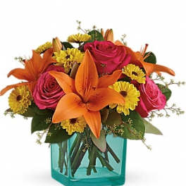 Orange lilies and pink roses in a turquoise vase