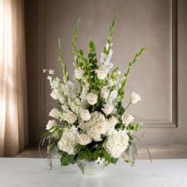 Tall white floral arrangement in a white vase