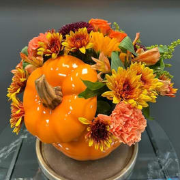 Pumpkin-shaped floral arrangement with orange and yellow blooms