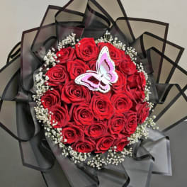 Red rose bouquet with baby's breath and a butterfly topper