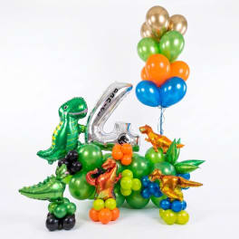 Dinosaur-themed balloon arrangement with a large silver number 4 and colorful balloons