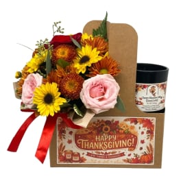 Thanksgiving gift set with a mixed flower bouquet, candle, and card