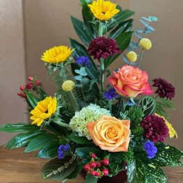 Mixed bouquet with roses, chrysanthemums, and hydrangea in a low vase