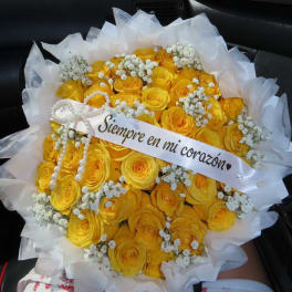 Bouquet of yellow roses with white baby's breath and a ribbon