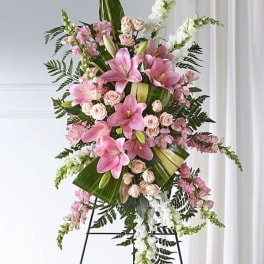 Pink lilies and roses arranged on a standing easel