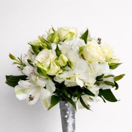 White bouquet with roses and lilies wrapped in silver ribbon