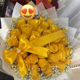 Bouquet of yellow roses with a satin ribbon and white filler flowers