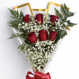 Bouquet of red roses and white baby's breath with a red ribbon