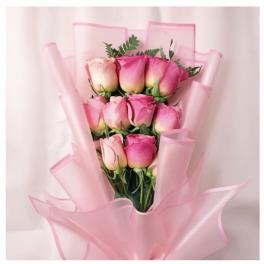 Bouquet of pink roses wrapped in sheer pink paper