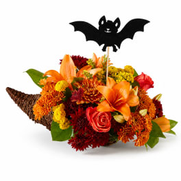 Halloween bouquet in a wicker horn with a bat topper