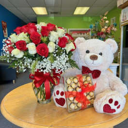 Red and white rose bouquet with a teddy bear and chocolates