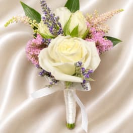 White rose boutonniere with purple and pink accent flowers