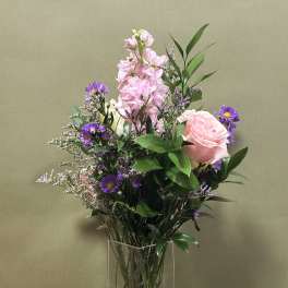 Pink and purple mixed bouquet in a clear glass vase
