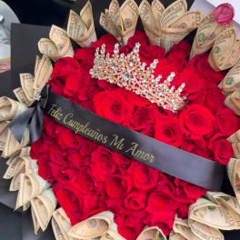 Red rose bouquet with folded dollar bills, a tiara, and a black ribbon