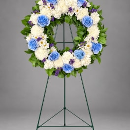 Blue and white floral wreath on a standing easel