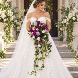 Bride holding a cascading bouquet of purple, lavender, and white flowers
