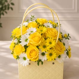 Yellow roses and white daisies in a pale basket with a handle