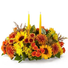 Autumn floral centerpiece with two yellow candles