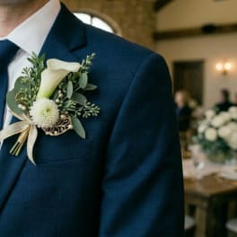 White boutonniere on a navy suit jacket