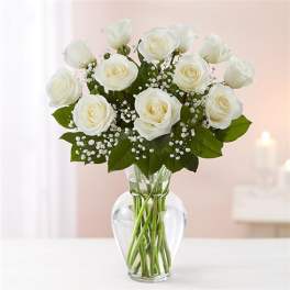 White roses arranged in a clear glass vase